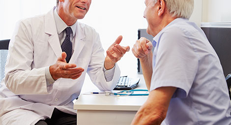 A doctor speaking with an older man
